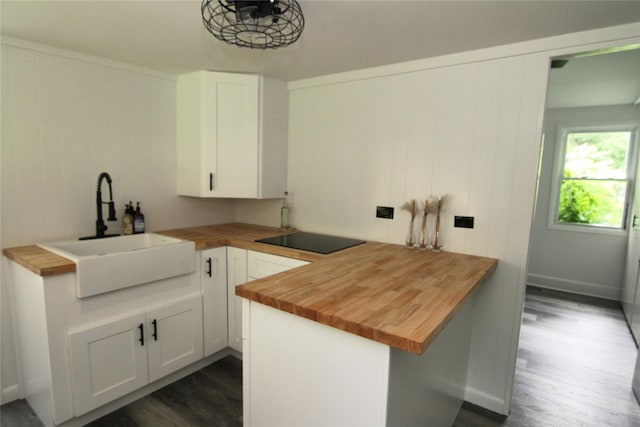 191 Sylvan Lake Rd Unit 1, Hopewell Junction, NY 12533 - kitchen with wood counters, black electric cooktop, dark wood-type flooring, and white cabinetry