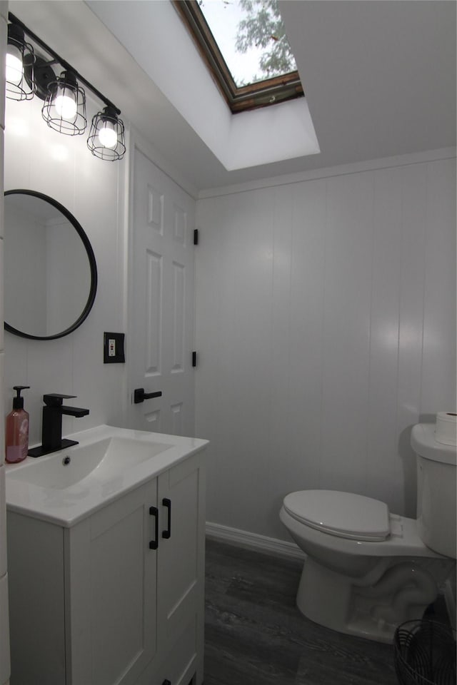 191 Sylvan Lake Rd Unit 1, Hopewell Junction, NY 12533 - bathroom featuring vanity, a skylight, wood finished floors, and a decorative wall
