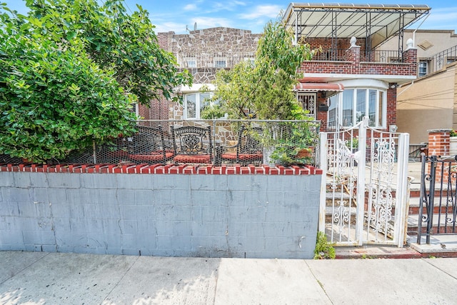 2168 37th St, Astoria, NY 11105 - view of front of home featuring a gate, a balcony, and brick siding