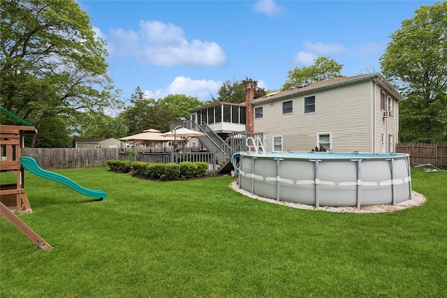 40 Dillmont Dr, Smithtown, NY 11787 - back of house with a sunroom, a gazebo, a fenced backyard, a playground, and a chimney