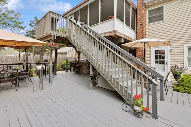 40 Dillmont Dr, Smithtown, NY 11787 - wooden deck featuring outdoor dining area, a gazebo, stairway, and a sunroom