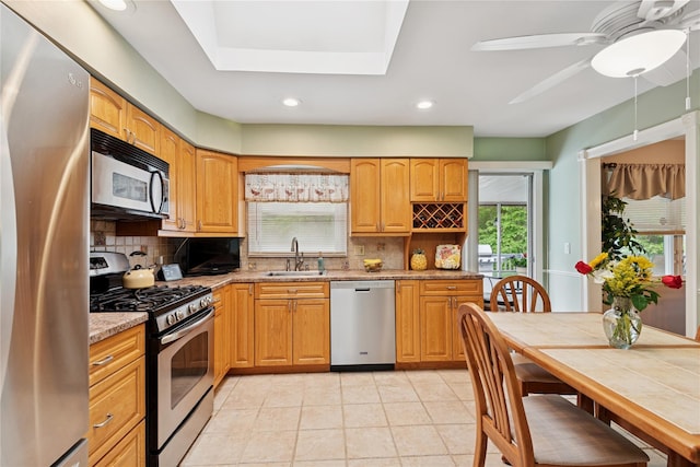 40 Dillmont Dr, Smithtown, NY 11787 - kitchen featuring appliances with stainless steel finishes, tasteful backsplash, recessed lighting, light stone counters, and light tile patterned floors