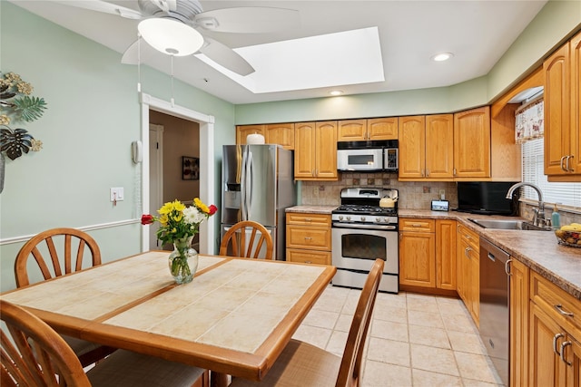 40 Dillmont Dr, Smithtown, NY 11787 - kitchen featuring appliances with stainless steel finishes, a skylight, decorative backsplash, a ceiling fan, and recessed lighting