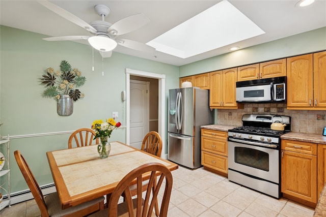 40 Dillmont Dr, Smithtown, NY 11787 - kitchen featuring appliances with stainless steel finishes, a baseboard heating unit, tasteful backsplash, recessed lighting, and a skylight