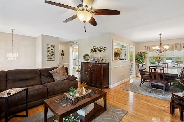 40 Dillmont Dr, Smithtown, NY 11787 - living room featuring a chandelier, a ceiling fan, and light wood-style floors
