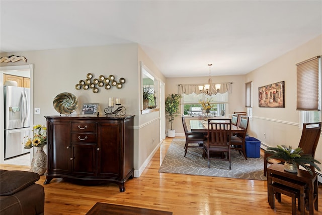 40 Dillmont Dr, Smithtown, NY 11787 - dining area featuring a chandelier, light wood-type flooring, and a baseboard heating unit
