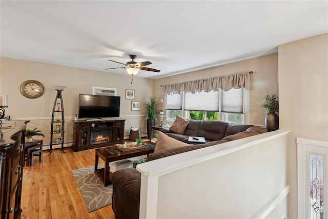 40 Dillmont Dr, Smithtown, NY 11787 - living room featuring a baseboard heating unit, ceiling fan, and light wood finished floors