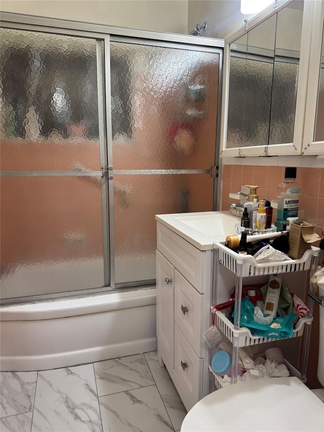 87-56 Francis Lewis Blvd Unit B31, Queens Village, NY 11427 - full bath featuring vanity, marble look tiles, shower / bath combination with glass door, and decorative backsplash