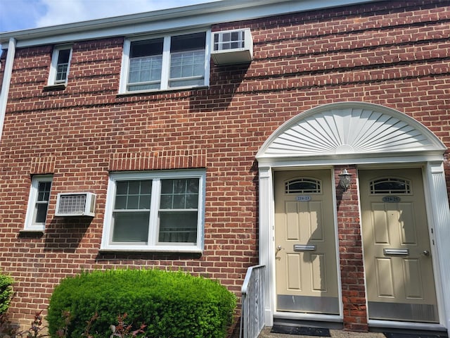 224-23 Kingsbury Ave Unit B, Oakland Gardens, NY 11364 - view of exterior entry with brick siding and a wall mounted AC