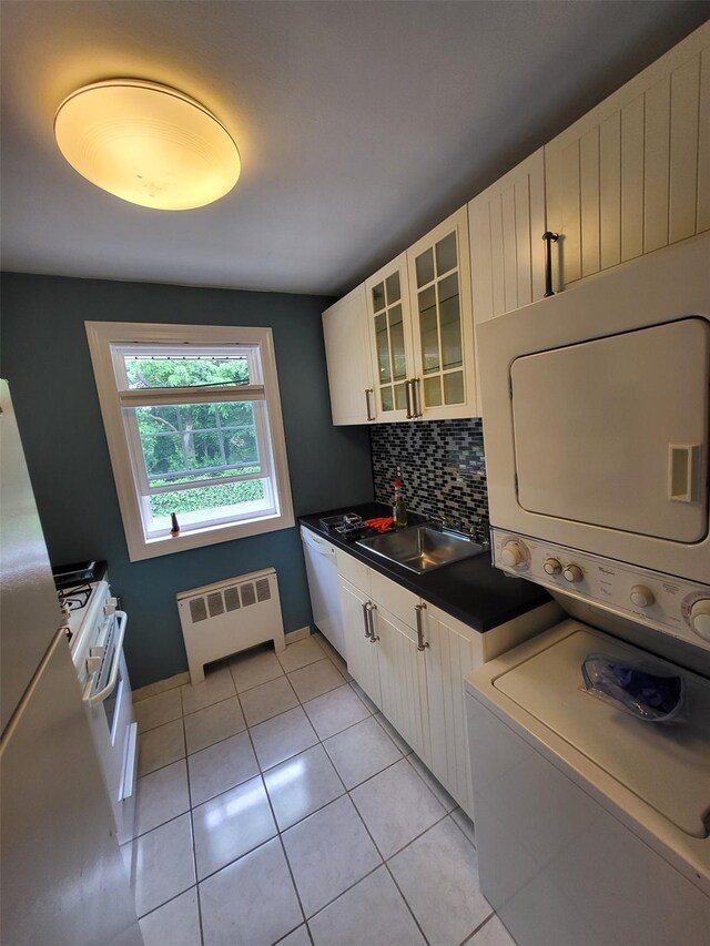 224-23 Kingsbury Ave Unit B, Oakland Gardens, NY 11364 - washroom featuring radiator heating unit, stacked washing machine and dryer, and light tile patterned floors