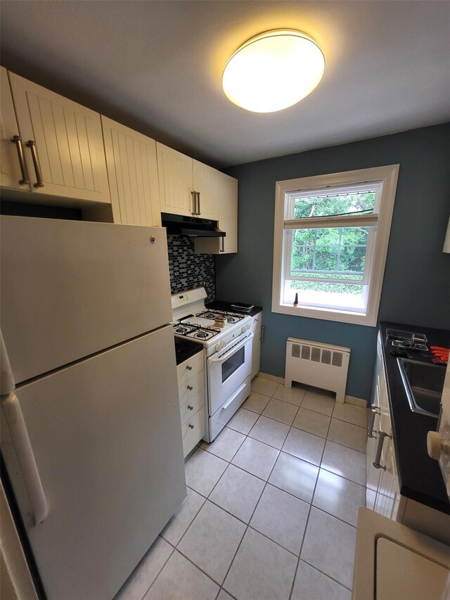 224-23 Kingsbury Ave Unit B, Oakland Gardens, NY 11364 - kitchen with white appliances, radiator heating unit, under cabinet range hood, tasteful backsplash, and light tile patterned floors