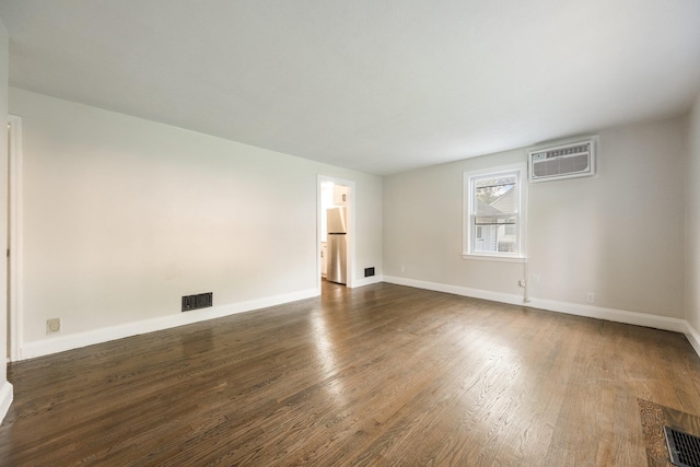 68 Henmond Blvd, Poughkeepsie, NY 12603 - empty room with a wall mounted AC and dark wood-style flooring