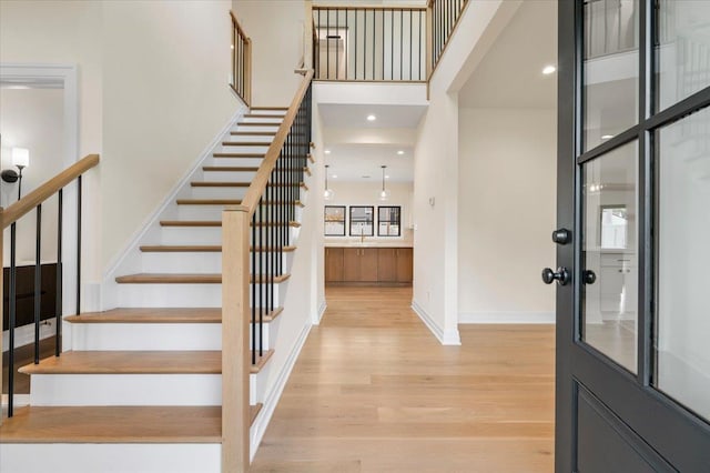 4 Haven Ln, Old Bethpage, NY 11804 - foyer entrance with light wood finished floors, stairway, and a high ceiling