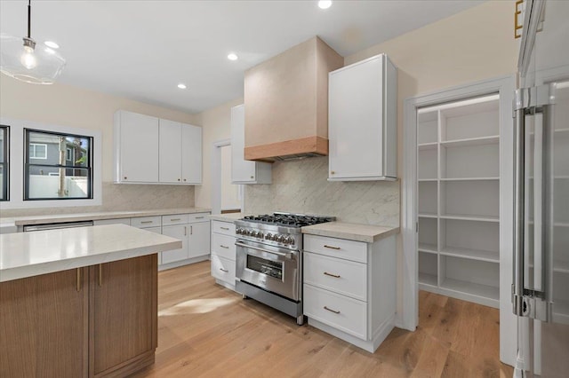 4 Haven Ln, Old Bethpage, NY 11804 - kitchen featuring high end stove, backsplash, white cabinetry, light wood-type flooring, and recessed lighting