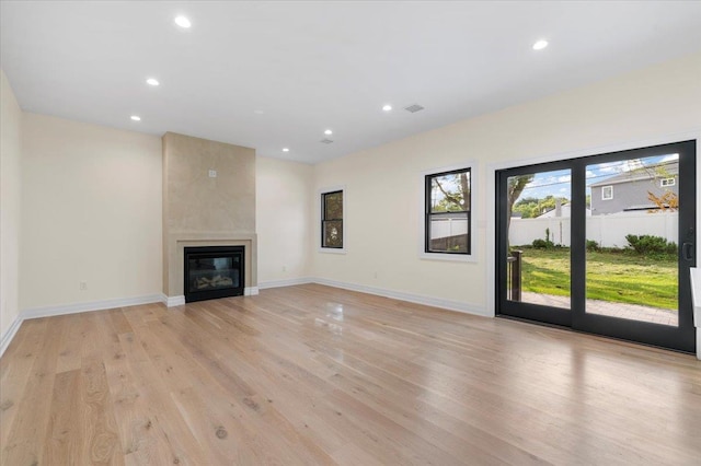 4 Haven Ln, Old Bethpage, NY 11804 - unfurnished living room with recessed lighting, light wood-style flooring, and a large fireplace