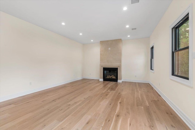 4 Haven Ln, Old Bethpage, NY 11804 - unfurnished living room with light wood-type flooring, a large fireplace, and recessed lighting
