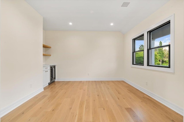 4 Haven Ln, Old Bethpage, NY 11804 - unfurnished living room with light wood-type flooring, beverage cooler, and recessed lighting