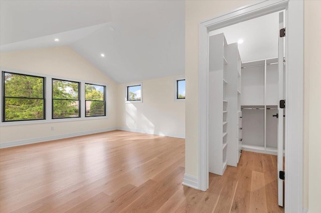4 Haven Ln, Old Bethpage, NY 11804 - unfurnished bedroom featuring a walk in closet, light wood finished floors, vaulted ceiling, a closet, and recessed lighting