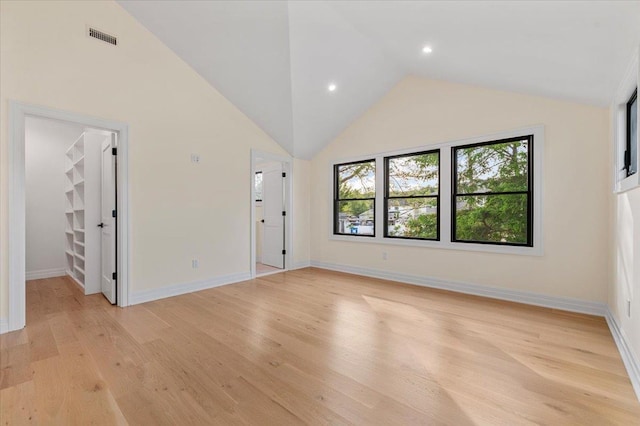 4 Haven Ln, Old Bethpage, NY 11804 - unfurnished bedroom with light wood-type flooring, vaulted ceiling, a walk in closet, and recessed lighting