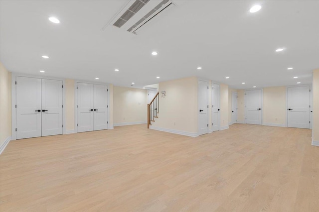 4 Haven Ln, Old Bethpage, NY 11804 - below grade area featuring light wood-style floors, stairway, and recessed lighting