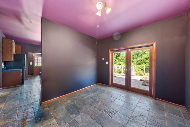 2706 Sound Ave, Calverton, NY 11933 - empty room featuring stone tile floors, french doors, and plenty of natural light