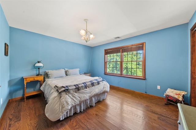 2706 Sound Ave, Calverton, NY 11933 - bedroom featuring wood finished floors and a chandelier