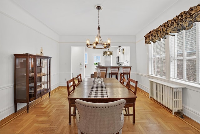 131 E 238th St, Bronx, NY 10470 - dining room featuring radiator and a chandelier