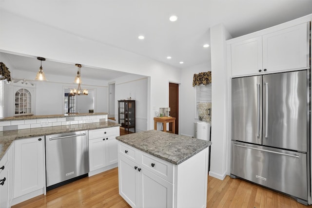 131 E 238th St, Bronx, NY 10470 - kitchen with stainless steel appliances, light wood finished floors, recessed lighting, white cabinetry, and light stone countertops