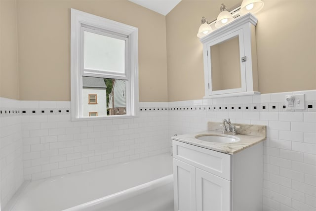 131 E 238th St, Bronx, NY 10470 - full bath with vanity, a garden tub, tile walls, and a wainscoted wall