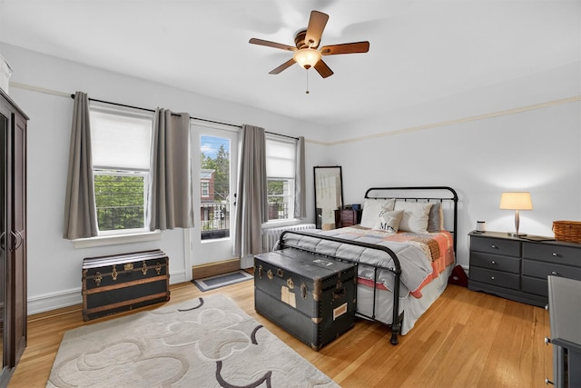 131 E 238th St, Bronx, NY 10470 - bedroom featuring light wood-style floors, access to exterior, and ceiling fan