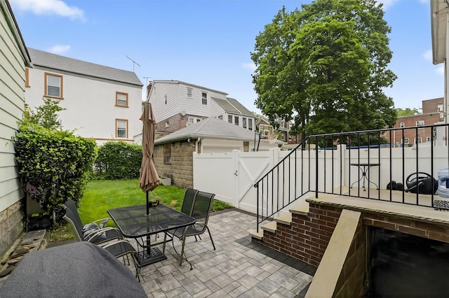131 E 238th St, Bronx, NY 10470 - fenced backyard featuring a patio area, a gate, a residential view, and outdoor dining space