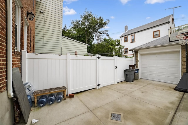 131 E 238th St, Bronx, NY 10470 - view of patio / terrace with driveway and a gate