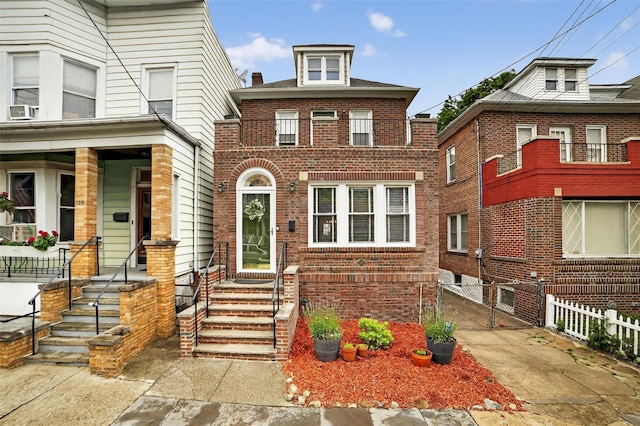 131 E 238th St, Bronx, NY 10470 - view of front of property featuring a gate, brick siding, cooling unit, and a porch