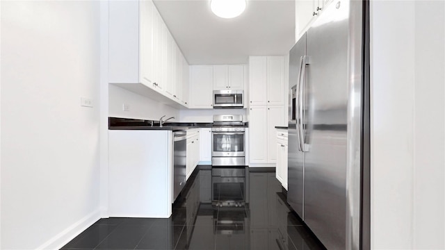 2500 Johnson Ave Unit 4L, Bronx, NY 10463 - kitchen with stainless steel appliances, dark countertops, white cabinetry, and dark tile patterned floors