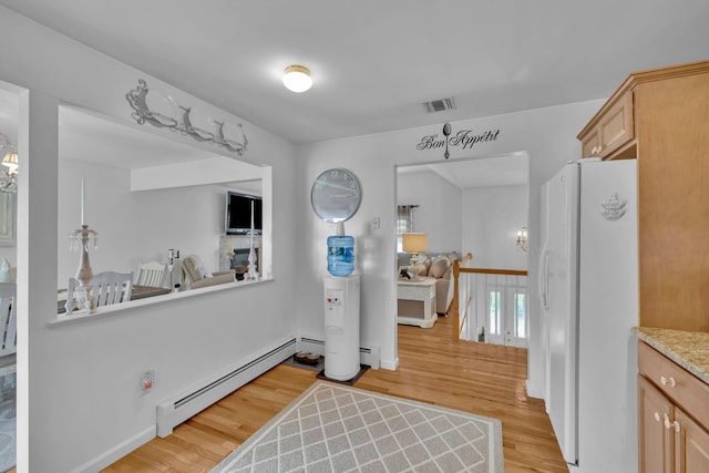 450 Mt Orange Rd, Middletown, NY 10940 - kitchen with freestanding refrigerator, a baseboard heating unit, light wood finished floors, light countertops, and open floor plan