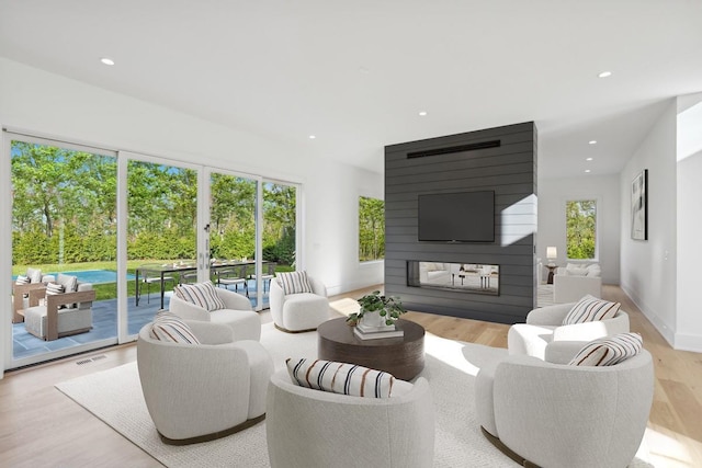 10 Broadwood Ct, Wainscott, NY 11975 - living room featuring wood finished floors, recessed lighting, and a multi sided fireplace