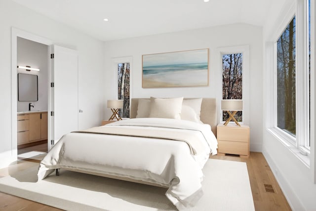 10 Broadwood Ct, Wainscott, NY 11975 - bedroom with light wood-style flooring, recessed lighting, ensuite bathroom, and multiple windows