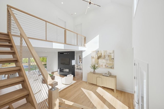10 Broadwood Ct, Wainscott, NY 11975 - staircase featuring a towering ceiling and wood finished floors