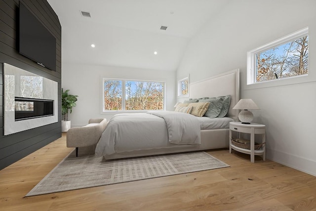 10 Broadwood Ct, Wainscott, NY 11975 - bedroom featuring recessed lighting, wood finished floors, a fireplace, and high vaulted ceiling