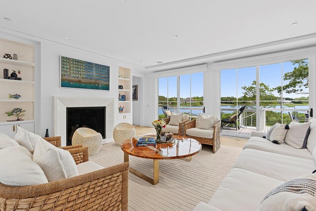 801 Montauk Hwy, Westhampton Beach, NY 11978 - living room with built in features, plenty of natural light, a water view, and recessed lighting