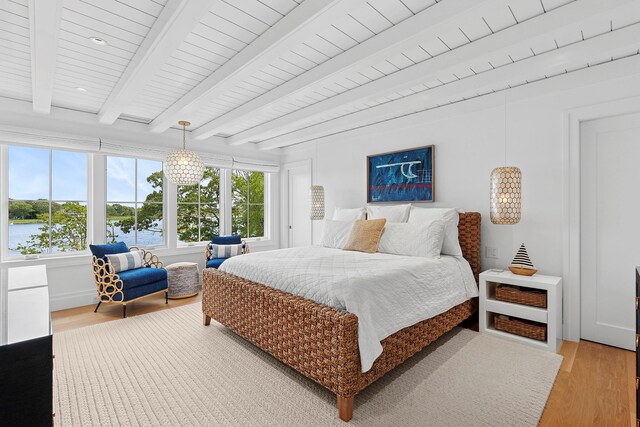 801 Montauk Hwy, Westhampton Beach, NY 11978 - bedroom featuring light wood-style floors and beamed ceiling