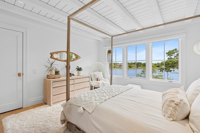 801 Montauk Hwy, Westhampton Beach, NY 11978 - bedroom with multiple windows, wood finished floors, a wooden ceiling with exposed beams, and a water view