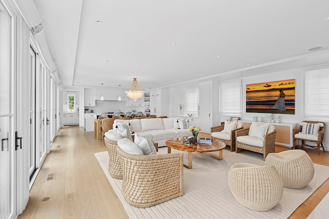 801 Montauk Hwy, Westhampton Beach, NY 11978 - living room with light wood-type flooring, recessed lighting, and a chandelier