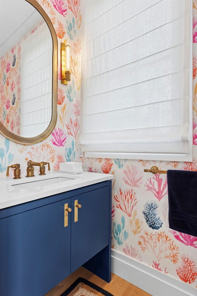 801 Montauk Hwy, Westhampton Beach, NY 11978 - bathroom featuring wallpapered walls, vanity, and wood finished floors