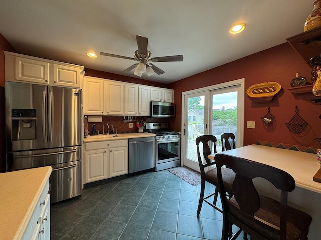 20 Bayberry Rd, Ronkonkoma, NY 11779 - kitchen with appliances with stainless steel finishes, light countertops, backsplash, white cabinets, and ceiling fan
