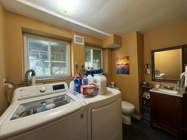20 Bayberry Rd, Ronkonkoma, NY 11779 - laundry area featuring dark tile patterned floors, washer and clothes dryer, and a textured ceiling