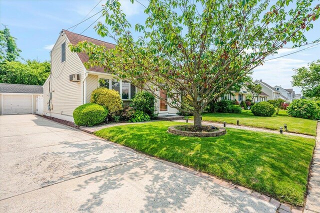 686 Barnes Ave, Baldwin, NY 11510 - obstructed view of property featuring an outdoor structure, driveway, a garage, and a front yard