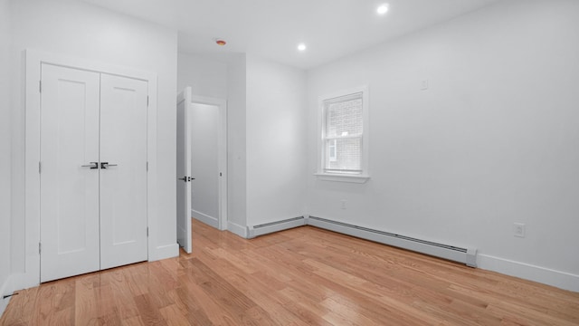 2825 Wellman Ave, Bronx, NY 10461 - unfurnished bedroom featuring light wood-type flooring, a baseboard radiator, recessed lighting, and a closet
