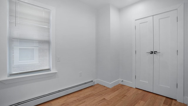 2825 Wellman Ave, Bronx, NY 10461 - spare room with a baseboard radiator and light wood-style flooring