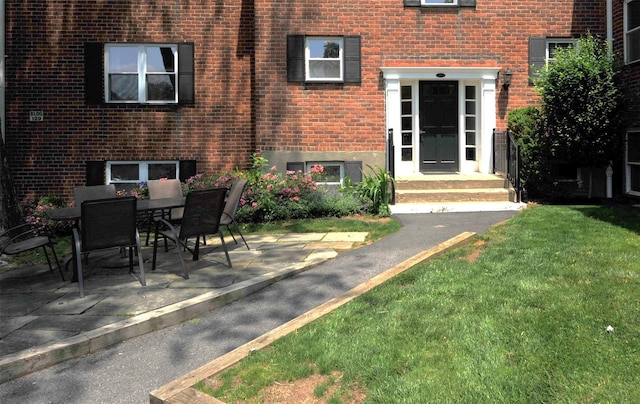 129-1 S Highland Ave Unit B6, Ossining, NY 10562 - property entrance featuring brick siding, a lawn, and a patio area
